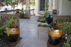 Tinted concrete patio with container plantings