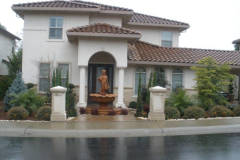Statue fountain with formal plantings