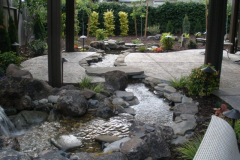 Custom waterfall with stream going through patio