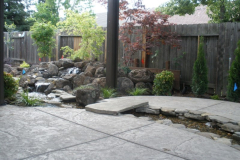Waterfall with stream and bridge