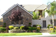 Raised planter with cultured stone