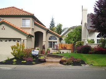 Wide view of the home's front yard and entry way.